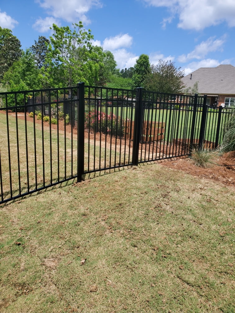 Black metal fence and gate installed by Bravo Fence at an Alabama home